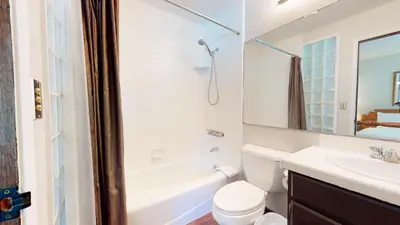 a bathroom with a sink and a toilet and a bath tub at Mammoth West #106 Condo in Mammoth Lakes