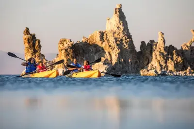 a group of people kayaking on the water near rocks at Mammoth West #106 Condo in Mammoth Lakes