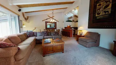 a living room with a couch and a table at Chateau De Montagne #42 Condo in Mammoth Lakes