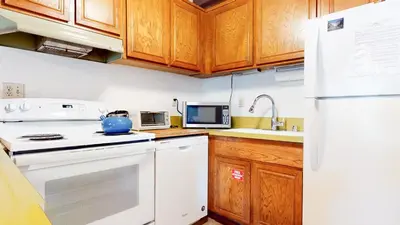 a kitchen with white appliances and wooden cabinets at Val D'Isere #6 Condo in Mammoth Lakes