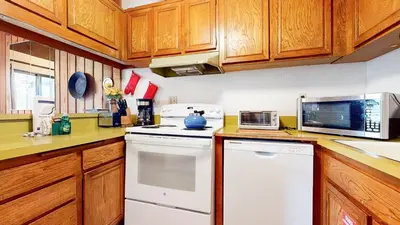 a kitchen with a white stove and a microwave at Val D'Isere #6 Condo in Mammoth Lakes