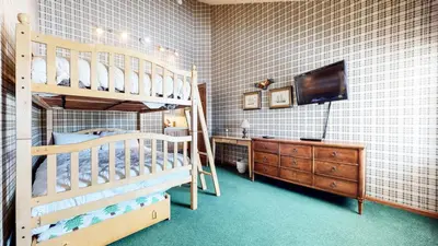 a bedroom with two bunk beds and a television at Sierra Megeve #8 Condo in Mammoth Lakes