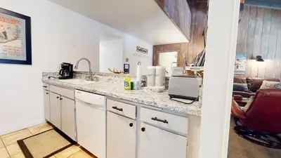 a kitchen with a counter with a sink and a microwave at Horizons 4 #150 Condo in Mammoth Lakes