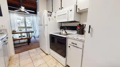 a kitchen with a white refrigerator and a sink at Horizons 4 #150 Condo in Mammoth Lakes