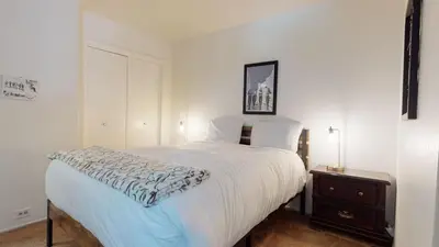 a bedroom with a white bed with a night stand at Horizons 4 #150 Condo in Mammoth Lakes