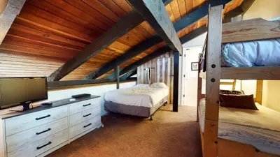 a bedroom with two bunk beds and a tv at Horizons 4 #150 Condo in Mammoth Lakes