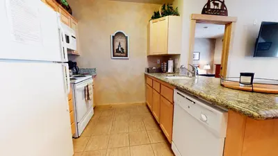 a kitchen with a white refrigerator and a sink at Sunstone #114 Condo in Mammoth Lakes