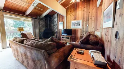 a living room with leather couches and a table at Condo de los Pinos #30 in Mammoth Lakes