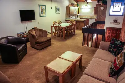 a living room with a couch and chairs and a table at Mammoth West #111 Condo in Mammoth Lakes