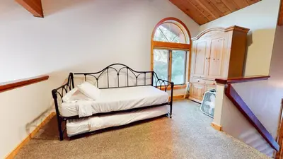 a bedroom with a bed and a window at Bridges Townhome #15 Condo in Mammoth Lakes