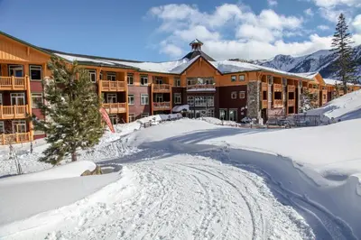 a lodge in the snow with a road in front at Sunstone #103 Condo in Mammoth Lakes