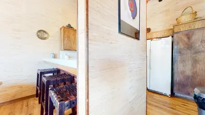 a kitchen with a counter and a refrigerator at Mammoth West #124 Condo in Mammoth Lakes