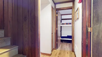 a hallway with a bunk bed in a room at Mammoth West #124 Condo in Mammoth Lakes