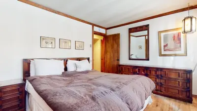 a bedroom with a large bed and a mirror at Mammoth West #124 Condo in Mammoth Lakes