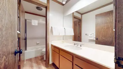 a bathroom with a sink and a toilet and a mirror at Mammoth West #124 Condo in Mammoth Lakes