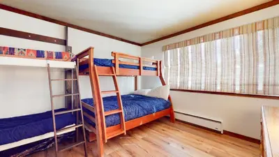 a bedroom with two bunk beds and a window at Mammoth West #124 Condo in Mammoth Lakes