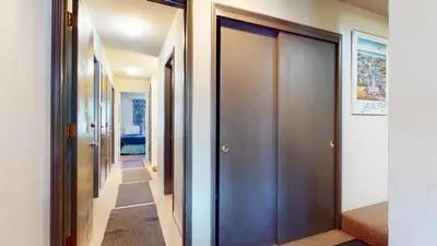 a hallway with wooden doors in a house at Chateau De Montagne #3 Condo in Mammoth Lakes