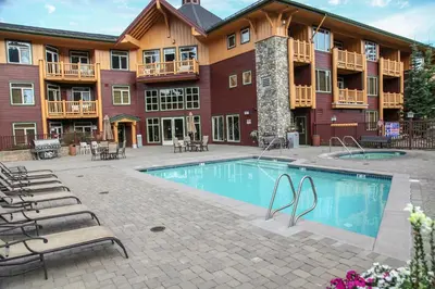 a hotel with a swimming pool in front of a building at Sunstone #208 Condo in Mammoth Lakes