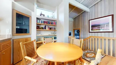 a dining room with a wooden table and chairs at Mammoth West #137 Condo in Mammoth Lakes