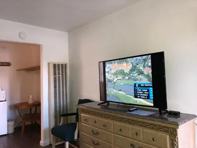 a flat screen tv sitting on top of a dresser at Cedar Inn & Suites in South Lake Tahoe