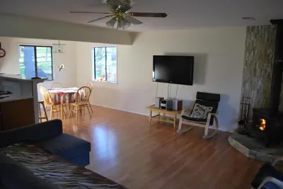a living room with a couch and a table and a television at Yosemite is Calling in Groveland