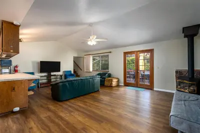 a living room with a couch and a table at Yosemite Falls Calling in Groveland
