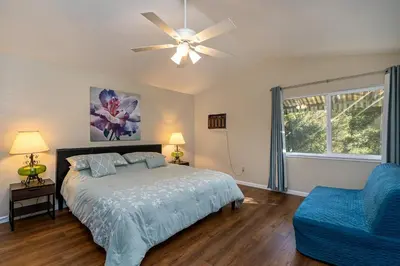 a bedroom with a bed and a ceiling fan at Yosemite Falls Calling in Groveland
