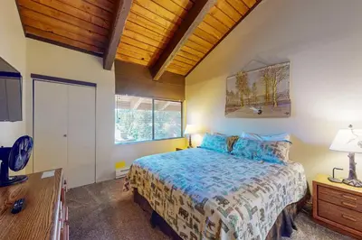 a bedroom with a bed and a wooden ceiling at Mammoth Ski & Racquet Club #131 in Mammoth Lakes