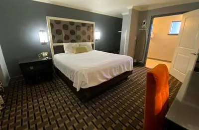 a hotel room with a bed and a chair at Budget INN At The Heavenly Gondola in South Lake Tahoe