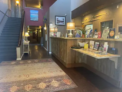 a restaurant with a counter and a staircase with a rug at Postmarc Hotel and Spa Suites in South Lake Tahoe