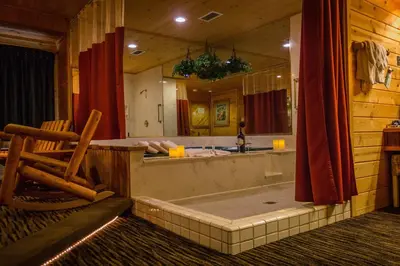 a bathroom with a tub and a large mirror at Postmarc Hotel and Spa Suites in South Lake Tahoe