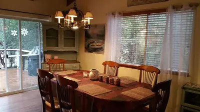 a dining room table with chairs and a table and a dining room at Lovely Mountain Lake Chalet by Yosemite: Equipped! in Groveland