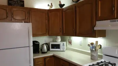 a kitchen with a white refrigerator and a microwave at Lovely Mountain Lake Chalet by Yosemite: Equipped! in Groveland
