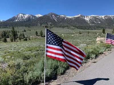 two american flags on the side of a road at Mountainback 79 Loft Den in Mammoth Lakes