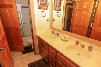 a bathroom with a sink and a mirror and a toilet at Mountainback 48 Corner Unit in Mammoth Lakes