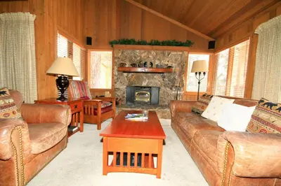 a living room with a couch and a fireplace at Mountainback 40 Loft Corner in Mammoth Lakes