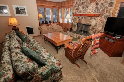 a living room with a couch and a fireplace at Mountainback 37 Den in Mammoth Lakes