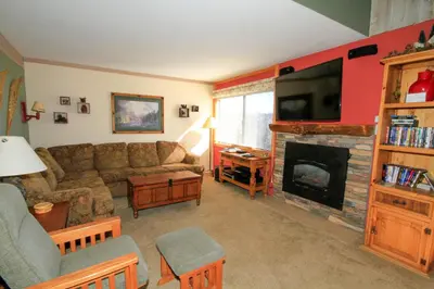 a living room with a couch and a fireplace at Mammoth Ski Racquet Club 64 - Pet Friendly in Mammoth Lakes