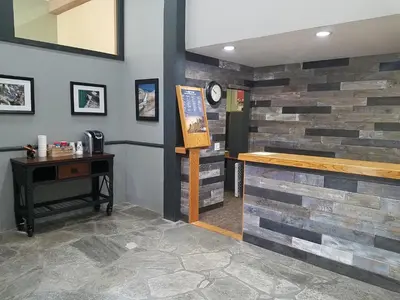 a bar in a restaurant with a stone wall at Mammoth Ski Racquet Club 64 - Pet Friendly in Mammoth Lakes