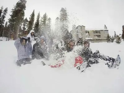 a group of people sitting in the snow at Mountainback 49 Den in Mammoth Lakes