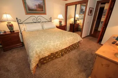 a bedroom with a large bed and two night stands at Mountainback 49 Den in Mammoth Lakes