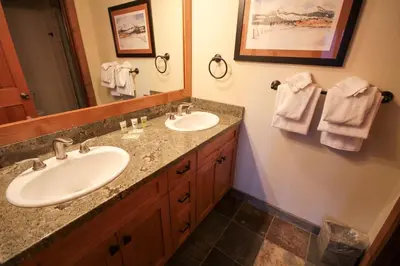 a bathroom with two sinks and a large mirror at Mountainback 52 Loft Corner in Mammoth Lakes