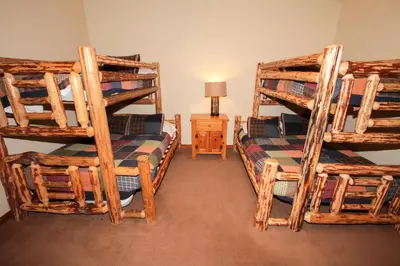 a bedroom with two bunk beds and a lamp at Mountainback 52 Loft Corner in Mammoth Lakes