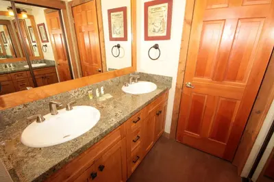 a bathroom with two sinks and a large mirror at Mountainback 52 Loft Corner in Mammoth Lakes