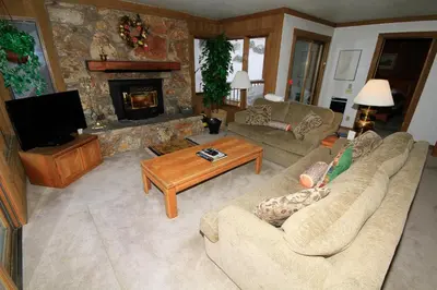 a living room with a couch and a fireplace at Mountainback 72 Corner Unit in Mammoth Lakes