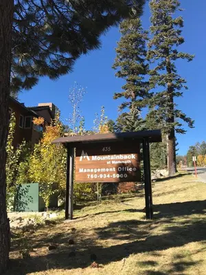 a sign in front of a building with a tree at Mountainback #71 in Mammoth Lakes