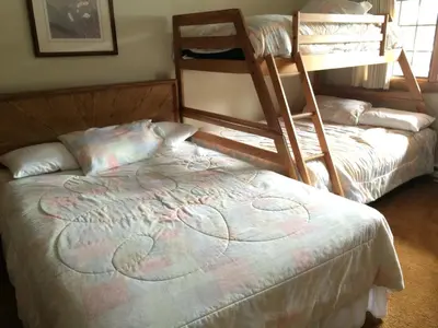 a bedroom with two bunk beds and a bed at Mountainback #71 in Mammoth Lakes