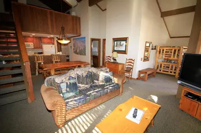 a living room with a couch and a table at Mountainback 63 Loft Den in Mammoth Lakes