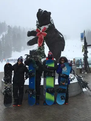 a group of people standing in front of a statue with snowboards at Mountainback 63 Loft Den in Mammoth Lakes