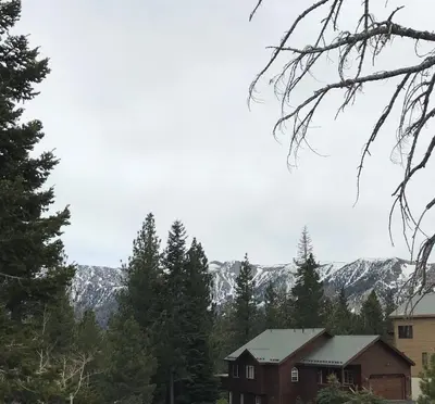 a house with trees and mountains in the background at Mountainback 57 Den in Mammoth Lakes